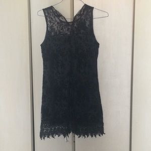 Black shift dress with lace overlay.